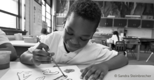 Alain Locke Charter School student working on a painting