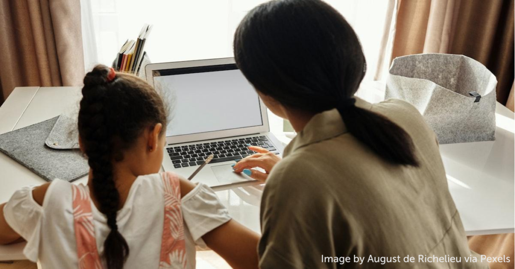 Woman and child work on computer together