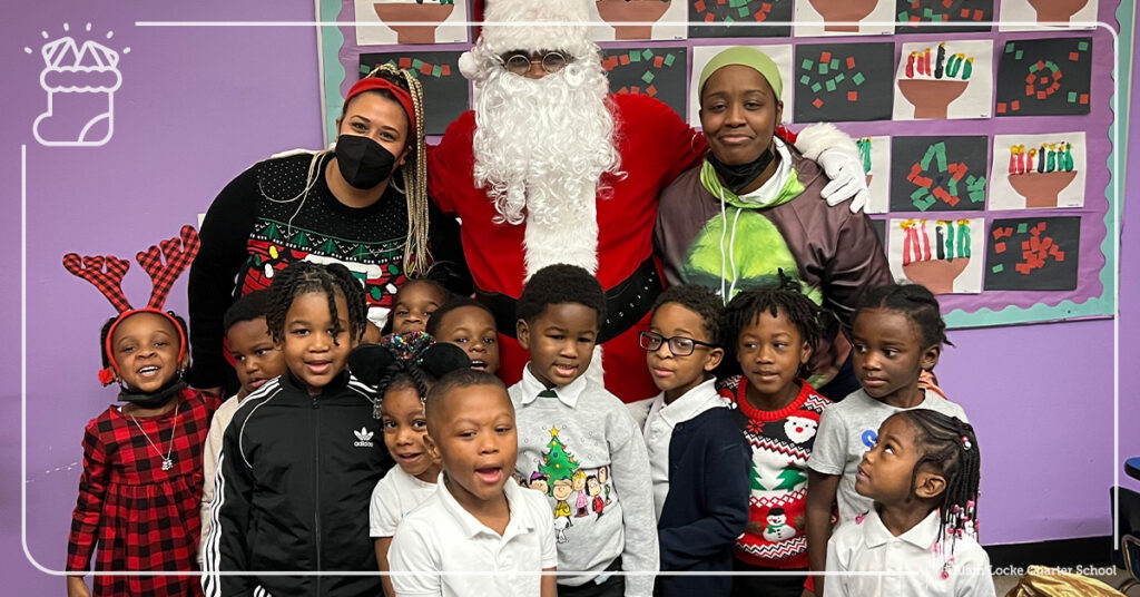 A group of all-stars pose for a photo opportunity with Santa during their visit at Alain Locke.
