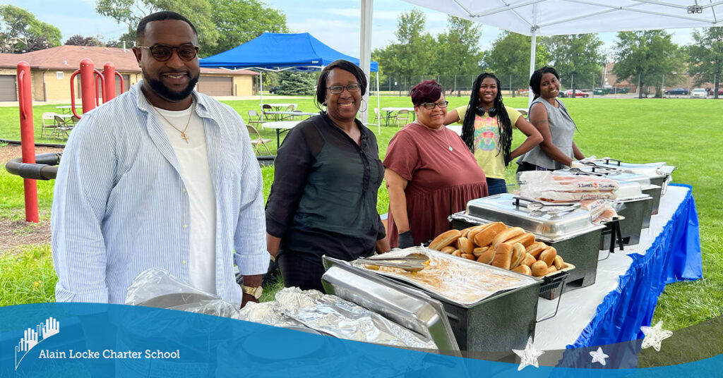 Smiling individuals ready to serve up food at the 2023-24 Alain Locke Open House + BBQ.